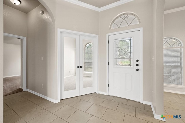 5620 Drystone Ln, Killeen, TX 76542 - entrance foyer with ornamental molding, french doors, light tile patterned flooring, baseboards, and arched walkways