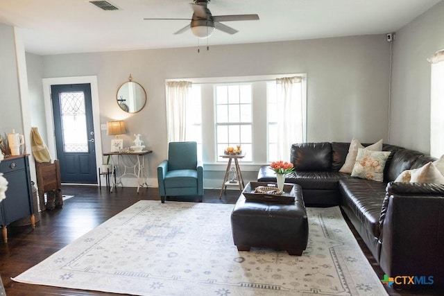 403 E 13th St, Shiner, TX 77984 - living area featuring a ceiling fan and dark wood-type flooring