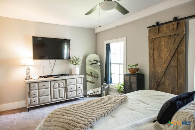 403 E 13th St, Shiner, TX 77984 - carpeted bedroom with a barn door and a ceiling fan