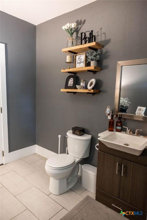 403 E 13th St, Shiner, TX 77984 - half bathroom featuring vanity and tile patterned floors