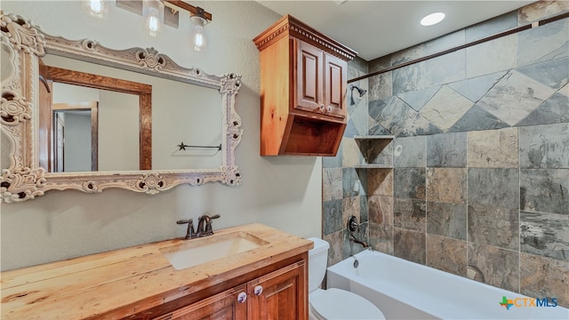 full bathroom with vanity, toilet, and tiled shower / bath combo