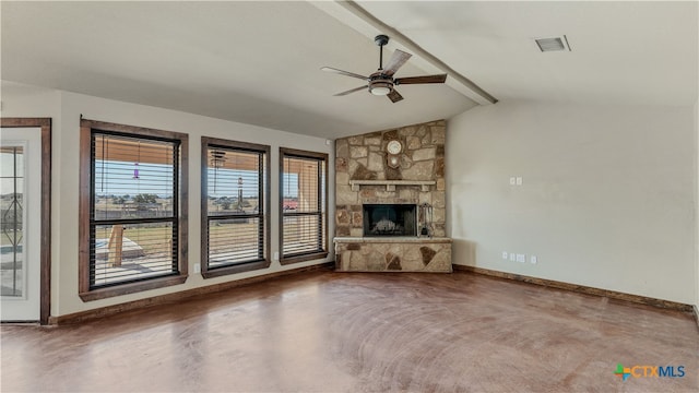 unfurnished living room with ceiling fan, a stone fireplace, and lofted ceiling with beams