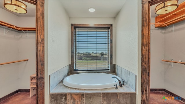 bathroom featuring tiled tub