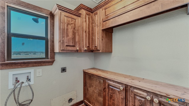 clothes washing area with cabinets, hookup for a washing machine, and electric dryer hookup