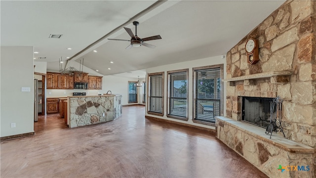 unfurnished living room featuring a fireplace, ceiling fan, concrete floors, and lofted ceiling with beams