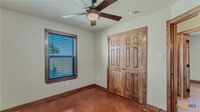 unfurnished bedroom featuring ceiling fan, a textured ceiling, a closet, and carpet