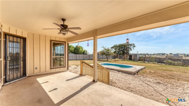 view of patio / terrace featuring a fenced in pool and ceiling fan