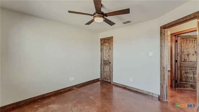 empty room with concrete flooring and ceiling fan