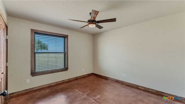 unfurnished room with ceiling fan and a textured ceiling