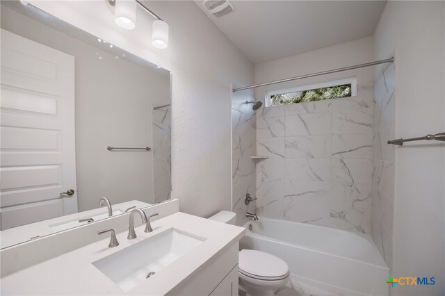 full bathroom with vanity, toilet, and tiled shower / bath