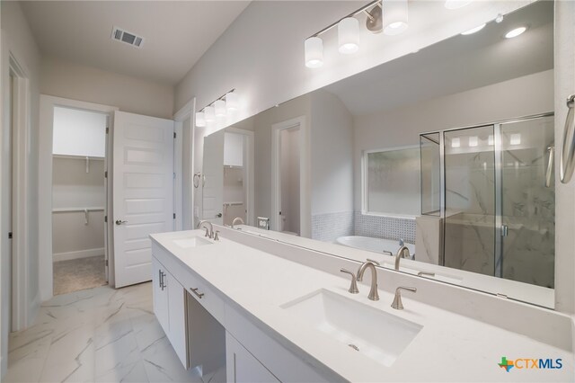 bathroom featuring vanity and plus walk in shower