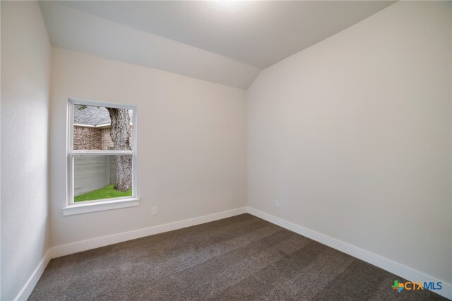 unfurnished room with carpet flooring and lofted ceiling