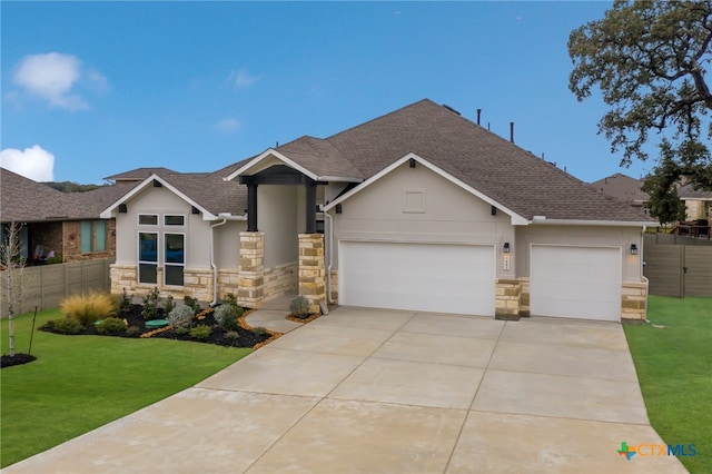 craftsman house featuring a garage and a front lawn