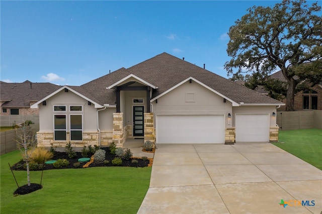 view of front of home with a front lawn and a garage