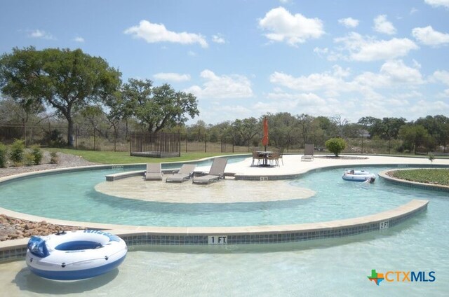 view of swimming pool featuring a patio area