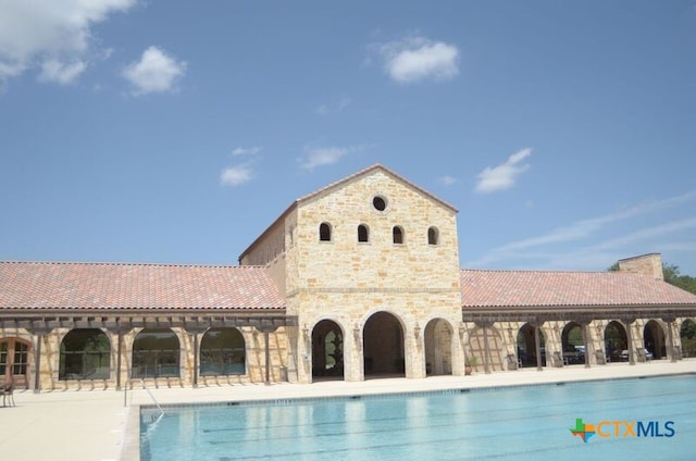 view of swimming pool with a patio area