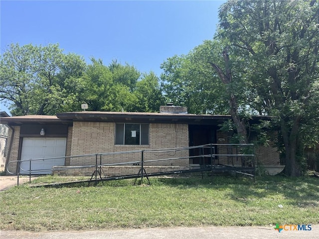 602 Stewart St, Killeen, TX 76541 - view of front facade featuring a garage, brick siding, and concrete driveway