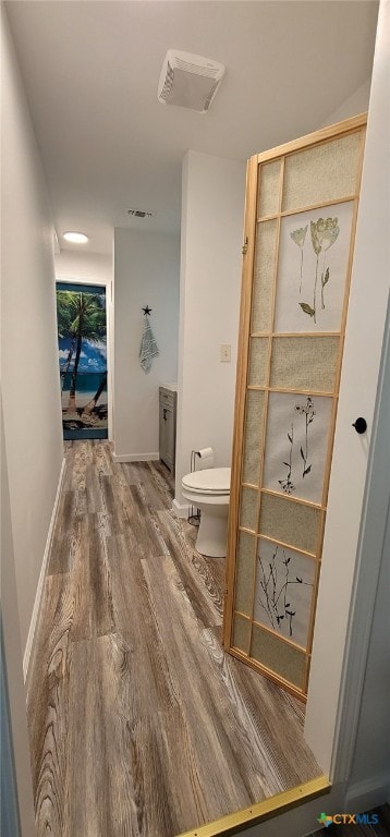 502 S 9th St, Seadrift, TX 77983 - bathroom featuring visible vents, toilet, and wood finished floors