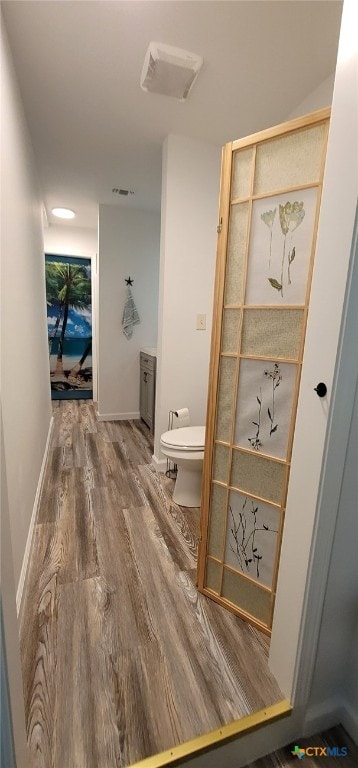 502 S 9th St, Seadrift, TX 77983 - bathroom featuring toilet and wood finished floors