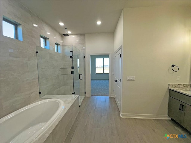 bathroom featuring separate shower and tub, vanity, and hardwood / wood-style flooring