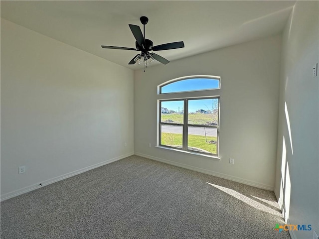 carpeted spare room featuring ceiling fan