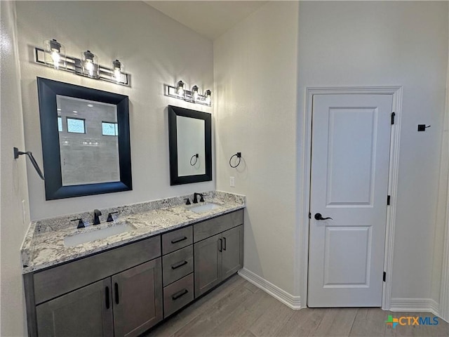 bathroom with vanity and hardwood / wood-style flooring