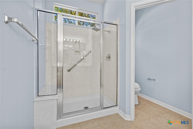 bathroom featuring toilet, tile patterned floors, and walk in shower