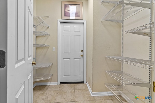 spacious closet featuring light tile patterned floors