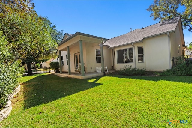 rear view of property with a lawn