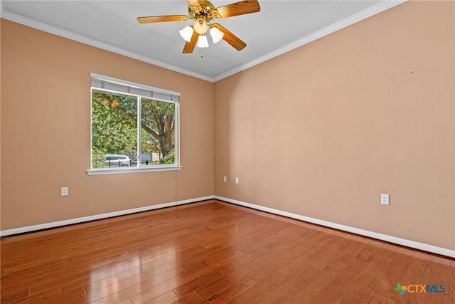 empty room featuring hardwood / wood-style flooring, ceiling fan, and ornamental molding