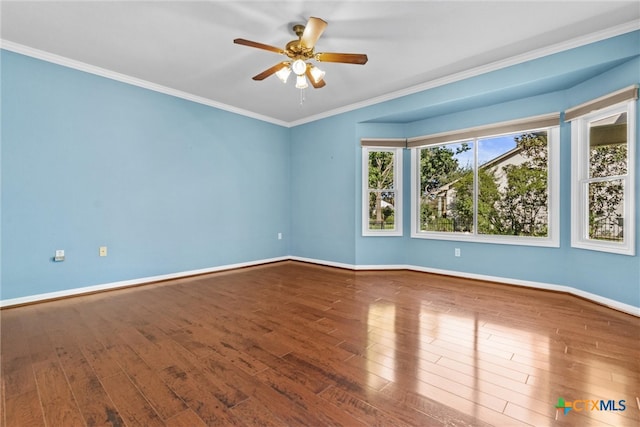 unfurnished room with hardwood / wood-style floors, ceiling fan, and crown molding