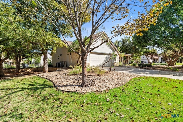 exterior space featuring a garage and a front lawn