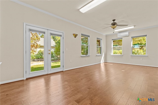 unfurnished room with french doors, ornamental molding, hardwood / wood-style flooring, a wall mounted air conditioner, and ceiling fan