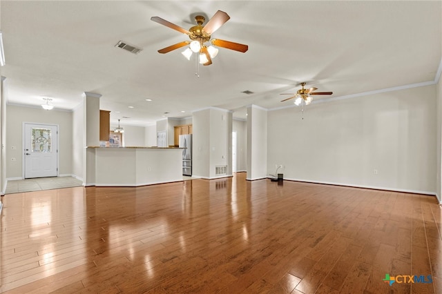 unfurnished living room with light hardwood / wood-style floors, ceiling fan, and crown molding