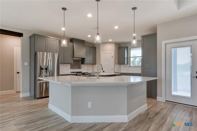 109 Wild Persimmon Trl, Marion, TX 78124 - kitchen featuring appliances with stainless steel finishes, gray cabinets, light wood-style flooring, tasteful backsplash, and recessed lighting