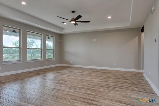 109 Wild Persimmon Trl, Marion, TX 78124 - unfurnished room featuring a tray ceiling, light wood-style flooring, a ceiling fan, and recessed lighting
