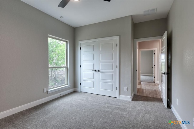 109 Wild Persimmon Trl, Marion, TX 78124 - unfurnished bedroom featuring carpet floors, a closet, and a ceiling fan