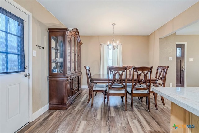 dining room with a chandelier and wood-type flooring