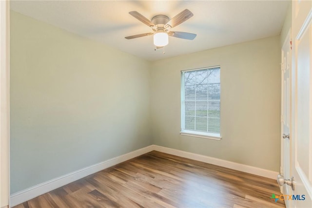 empty room with hardwood / wood-style flooring and ceiling fan