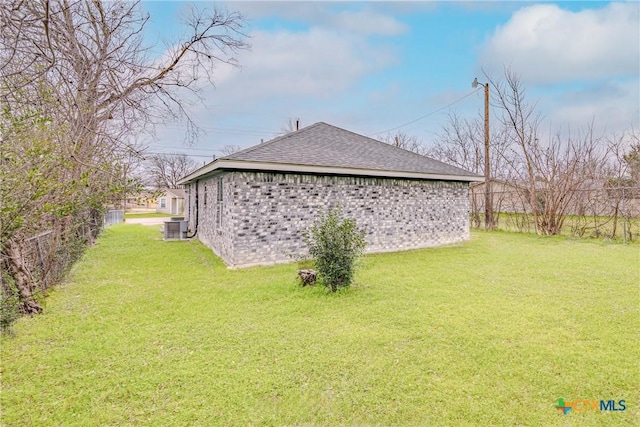 view of home's exterior with a lawn and central AC