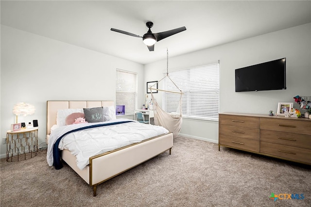 carpeted bedroom featuring ceiling fan and baseboards