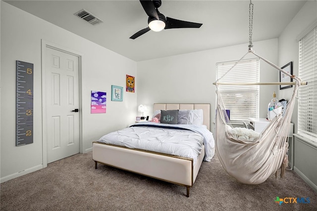 carpeted bedroom featuring baseboards, visible vents, and ceiling fan