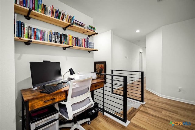 office space featuring recessed lighting, baseboards, and wood finished floors