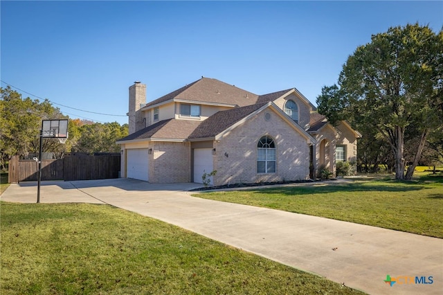 traditional home with brick siding, fence, a front yard, a chimney, and driveway