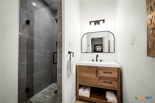 bathroom with vanity and a shower stall