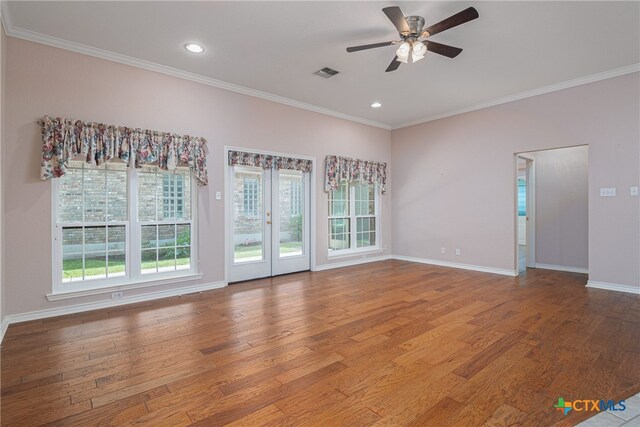 spare room with hardwood / wood-style floors, ceiling fan, and plenty of natural light