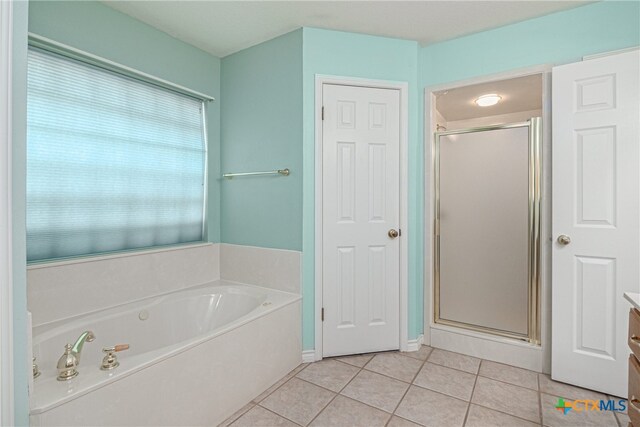 bathroom featuring vanity, tile patterned floors, and independent shower and bath