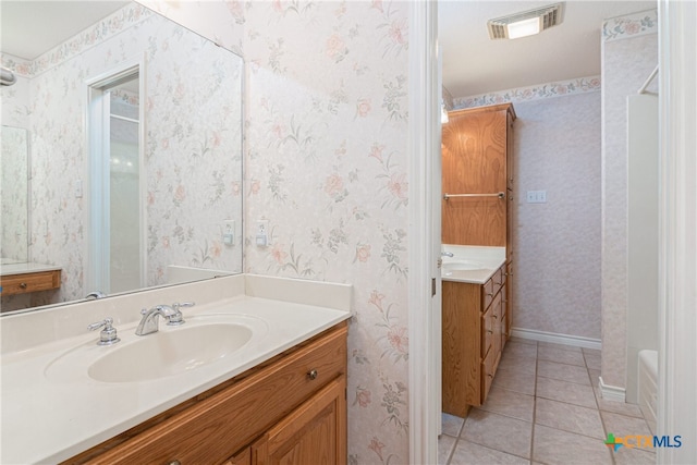 bathroom featuring a bath, vanity, and tile patterned floors