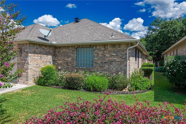 view of home's exterior with a lawn