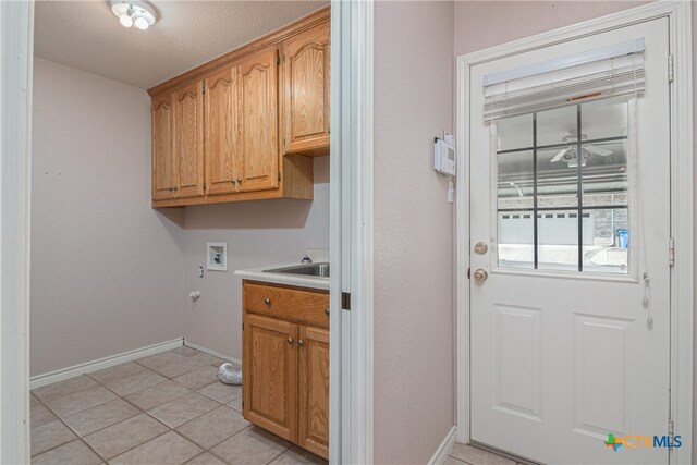 laundry area with cabinets, hookup for a washing machine, and light tile patterned floors